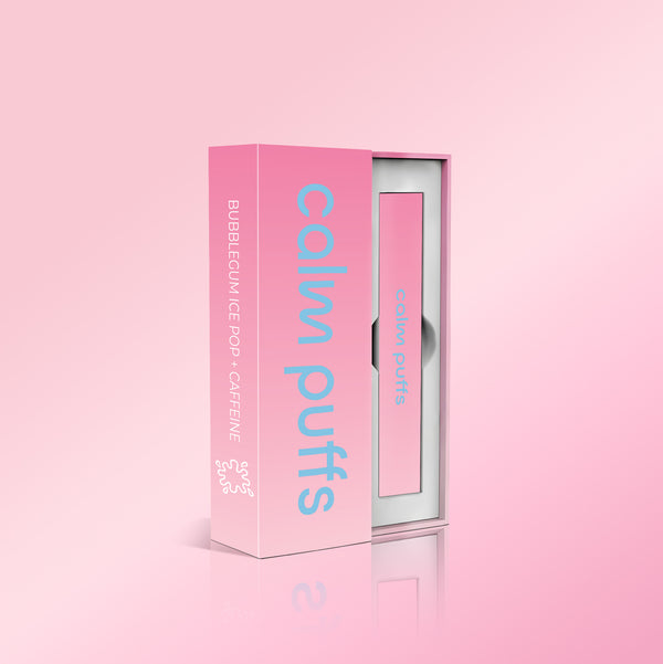 Calm Puffs Bubblegum Ice Pop + Caffeine diffuser in pink packaging displayed on a soft pink background, showcasing the vitamin-infused wellness puff